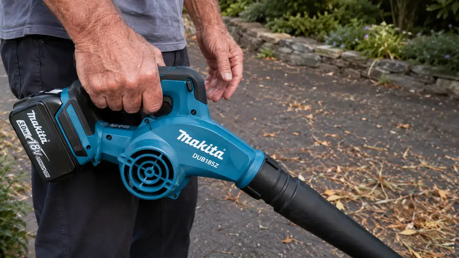 Hand gripping the Makita DUB185Z cordless blower, demonstrating the compact size and single-hand hold